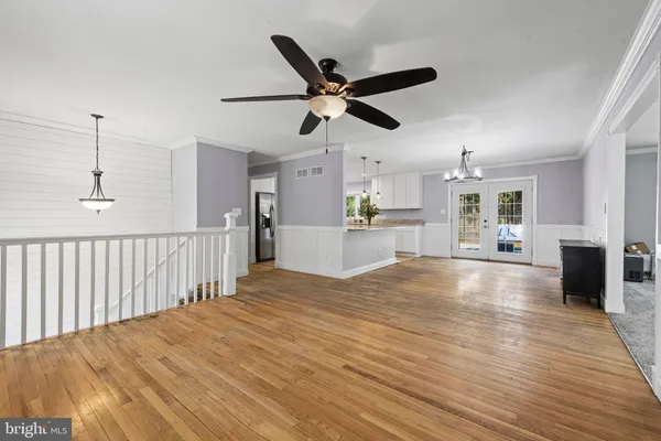 a spacious bedroom with a bed and a flat screen tv