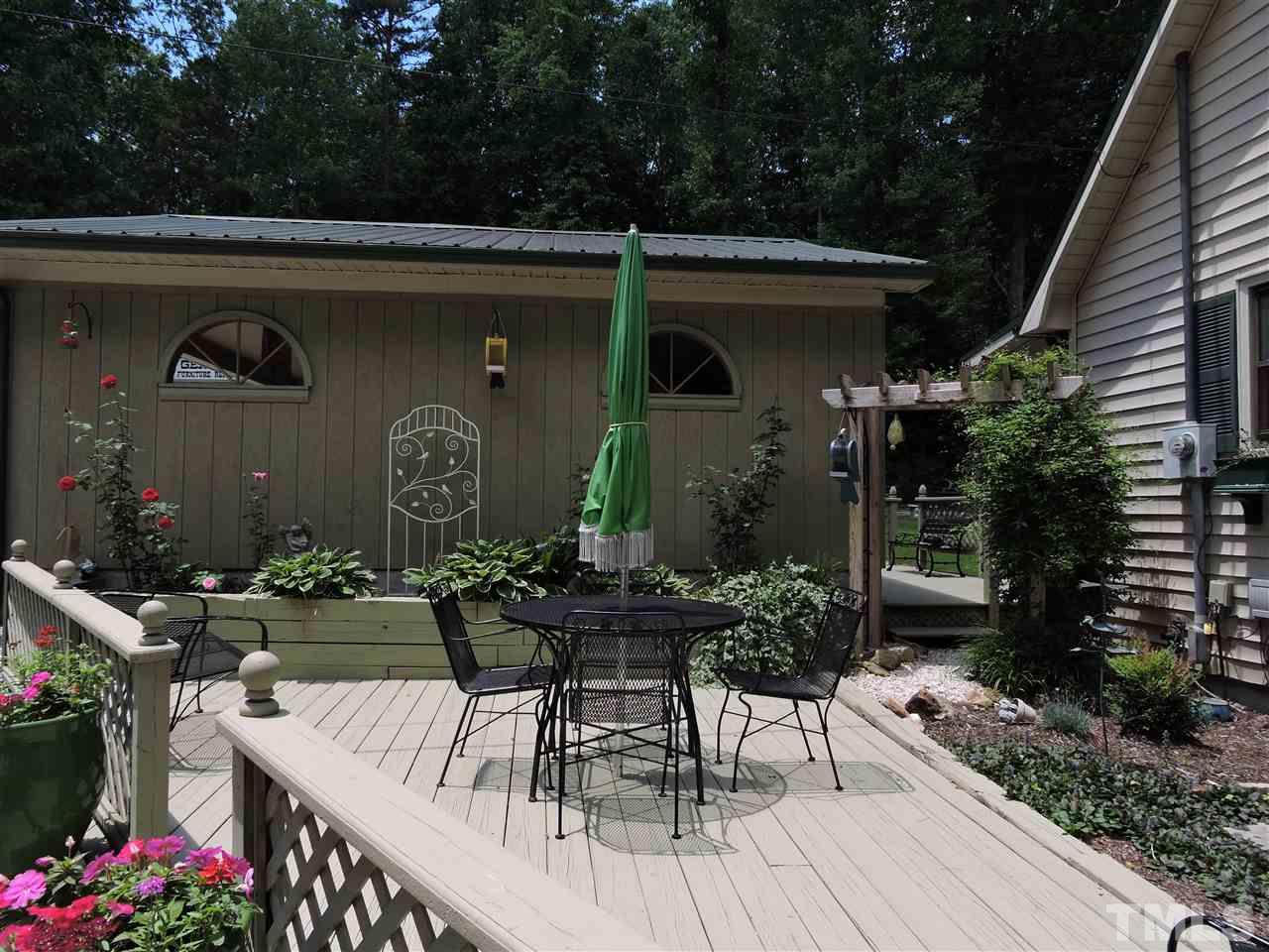 669 Ivey Day Road Roxboro, NC 27574 - Photo 3 of 24 a view of house with patio entertaining space with furniture and wooden floor
