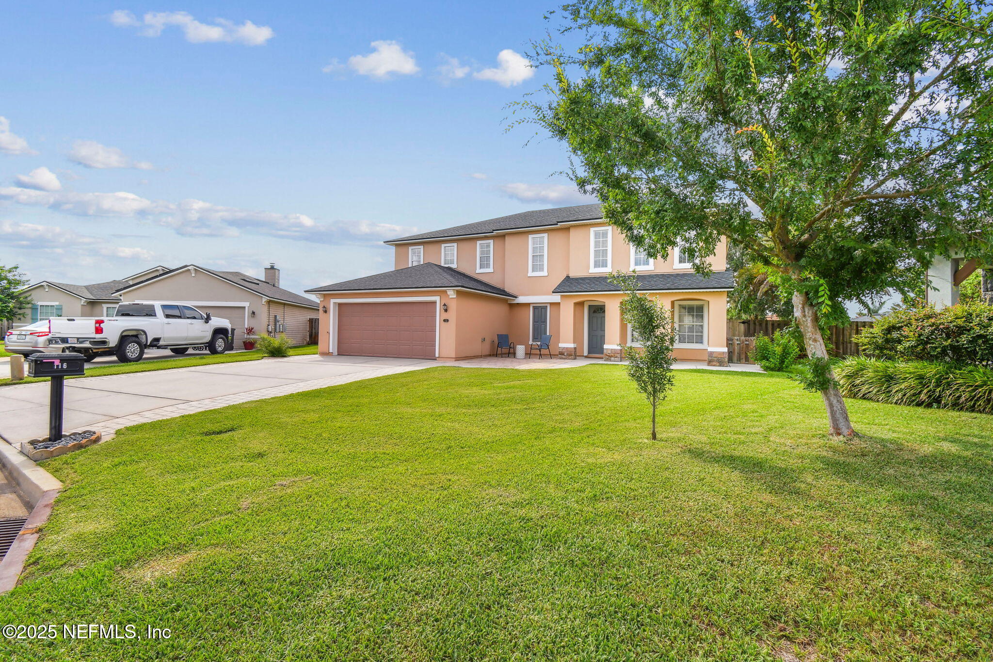 116 Nunna Rock Trail St. Augustine, FL 32092 - Photo 6 of 111 a yellow and red house with a garden