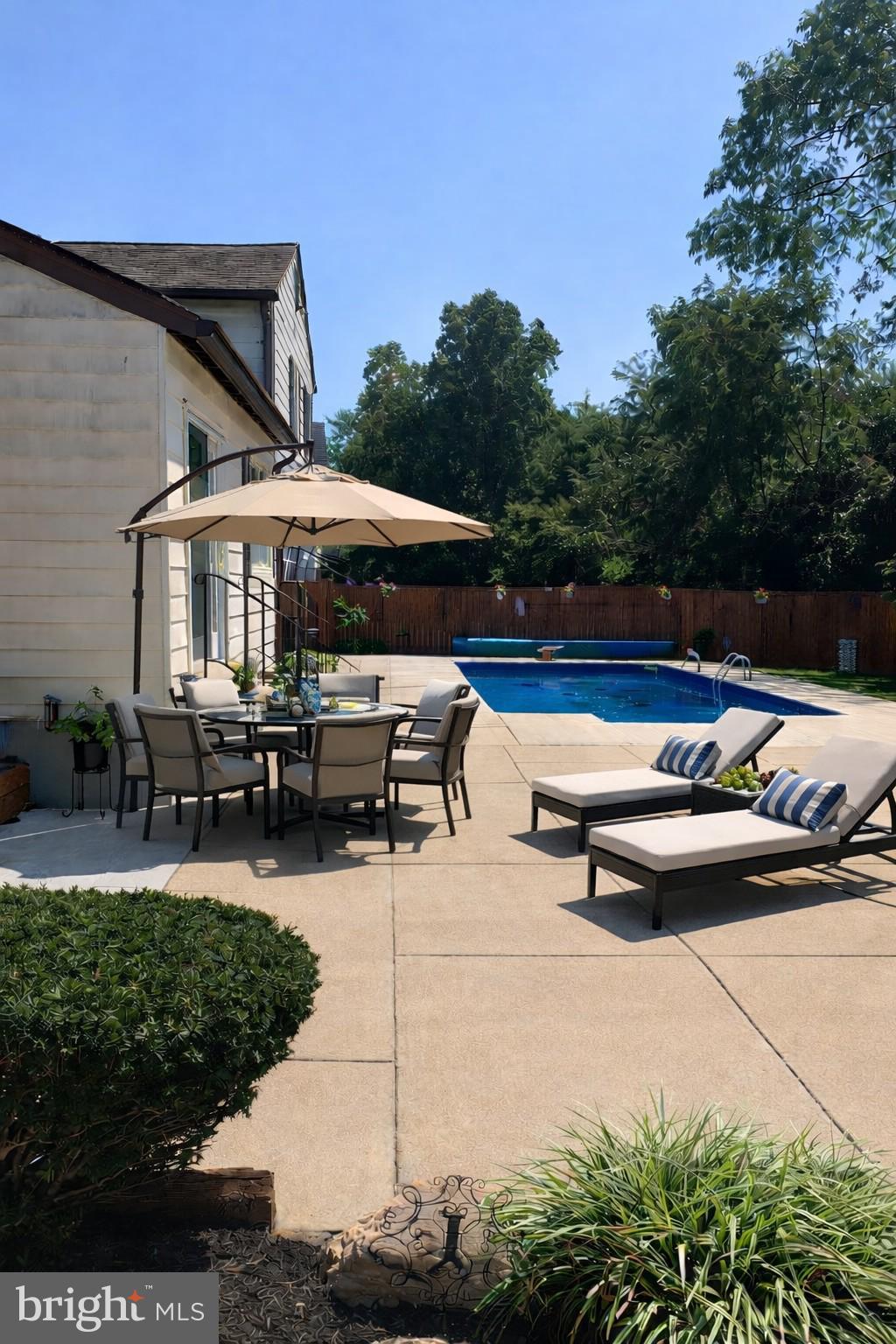 14216 Alderton Road Silver Spring, MD 20906 - Photo 2 of 14 a roof deck with table and chairs under an umbrella