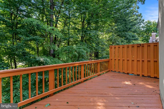 a balcony with wooden floor and fence