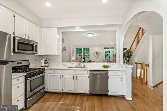 a kitchen with a sink cabinets and wooden floor