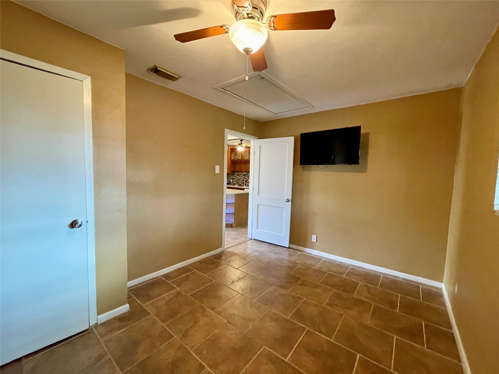 1113 Chevy Chase Drive Angleton, TX 77515 - Photo 13 of 32 a view of an empty room with a ceiling fan and window
