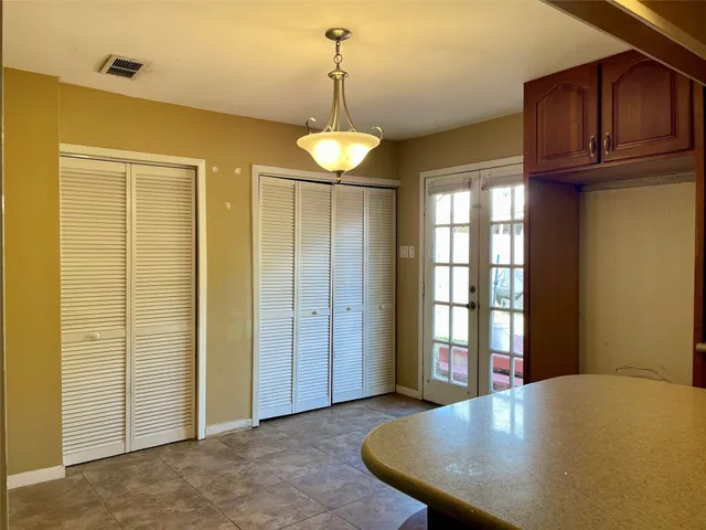 a view of a kitchen with a refrigerator cabinets and a wooden floor