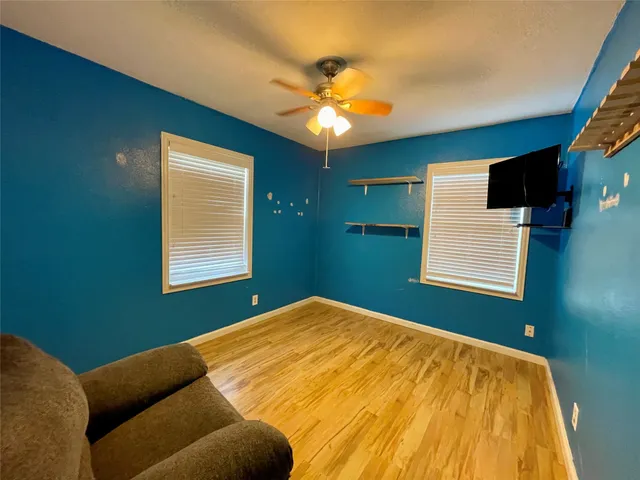 a view of a backyard with table and chairs under an umbrella