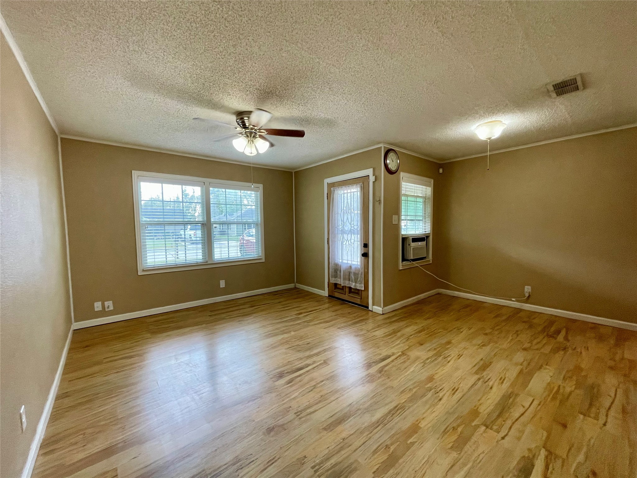 1113 Chevy Chase Drive Angleton, TX 77515 - Photo 6 of 32 an empty room with wooden floor and windows