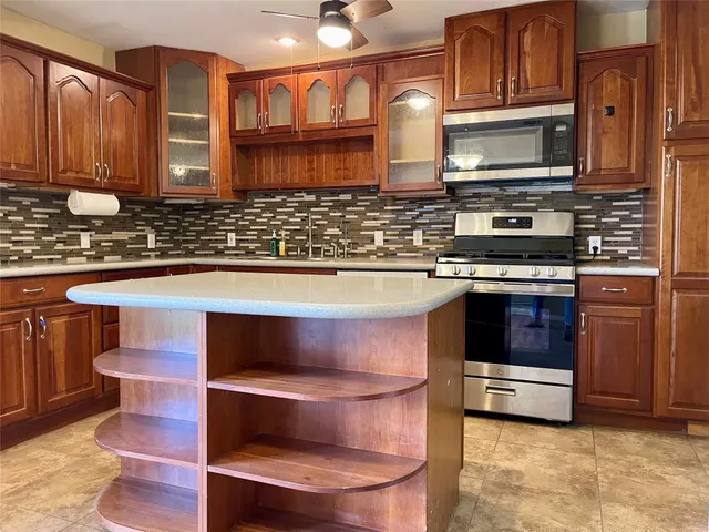 a kitchen with stainless steel appliances a stove a sink and a microwave