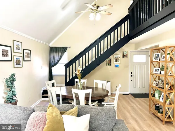 a living room with furniture and stairs