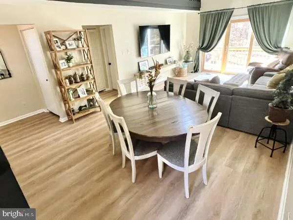 a view of a dining room with furniture wooden floor and a chandelier