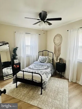 a bedroom with 2 bed and a dresser
