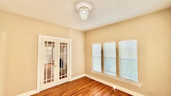 a view of a livingroom with wooden floor and a window