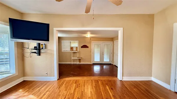 a view of a hallway with wooden floor and closet