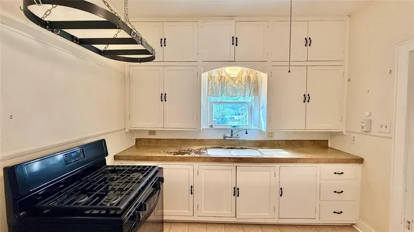 a kitchen with granite countertop a stove and a sink
