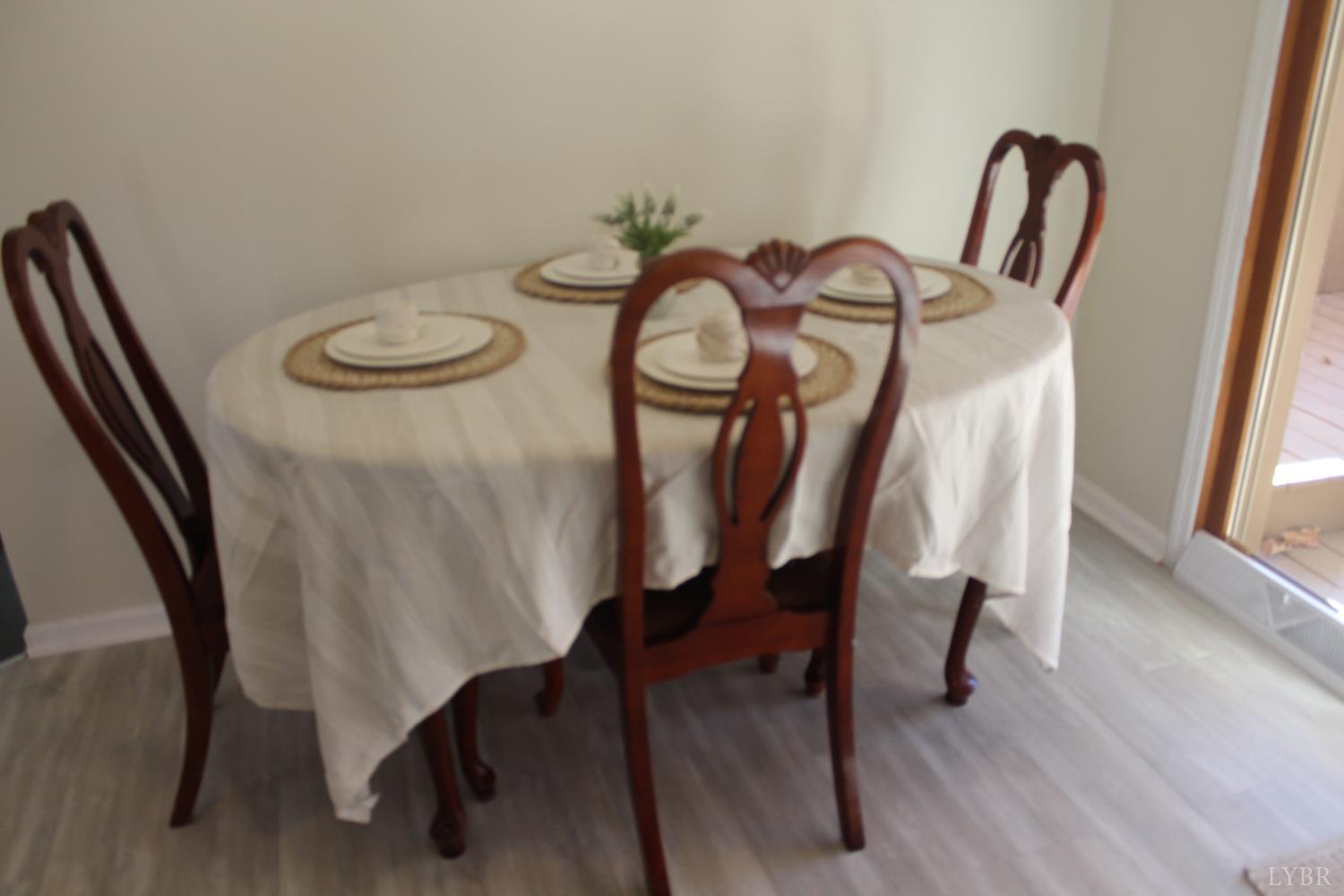 305 Eldon Road Appomattox, VA 24522 - Photo 12 of 24 a view of a dining room with furniture and wooden floor