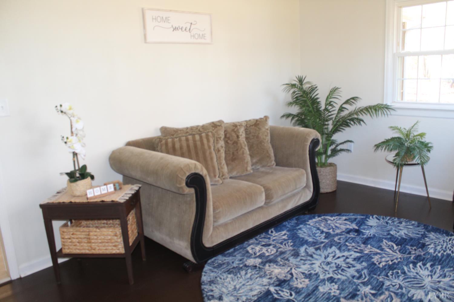 305 Eldon Road Appomattox, VA 24522 - Photo 10 of 24 a bed sitting in a bedroom next to a window with potted plant