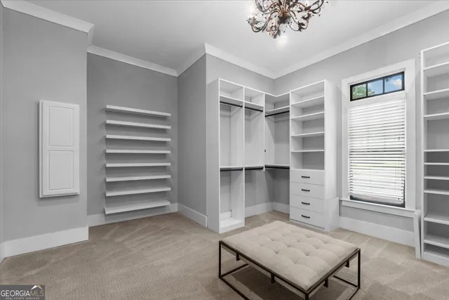 a view of an empty room with a window and fireplace