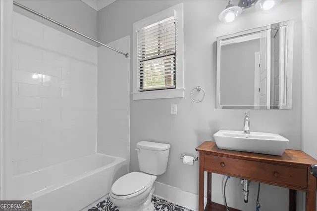 a kitchen with stainless steel appliances granite countertop a sink and a refrigerator