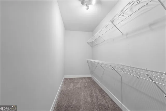 a view of an empty room with window and fire place