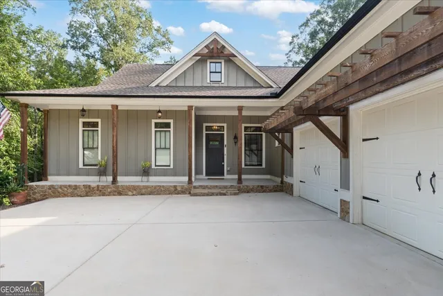 a front view of a house with a yard and trees