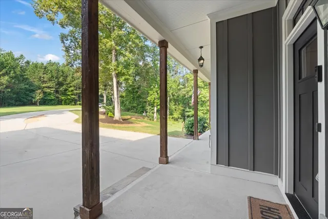 a view of a hallway with wooden floor and a window