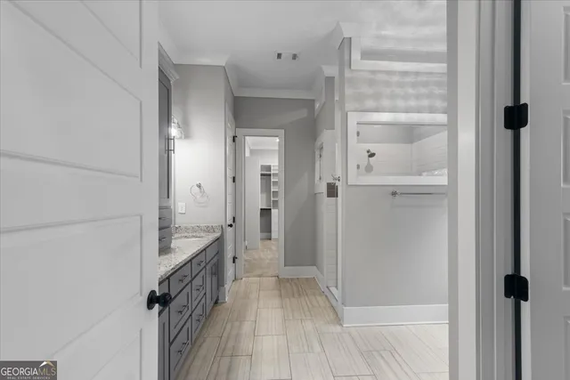a bathroom with a granite countertop sink mirror and a toilet
