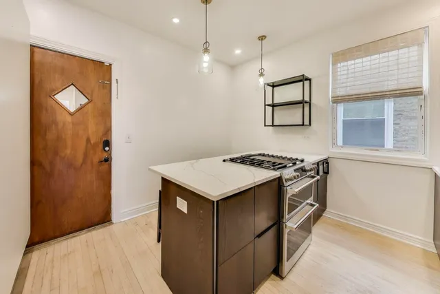 a kitchen with stainless steel appliances granite countertop a stove and a refrigerator