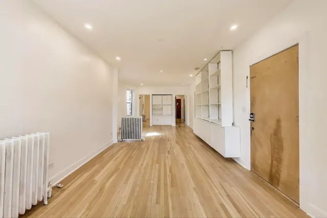 a view of hallway with wooden floor