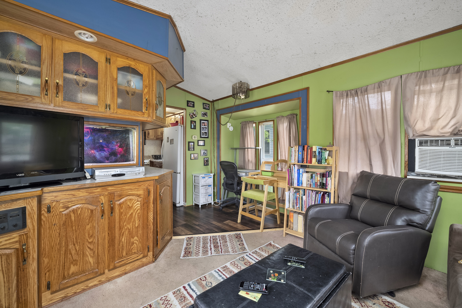 59 Dinosaur Road Wilmington, IL 60481 - Photo 7 of 17 a living room with furniture a flat screen tv and floor to ceiling window