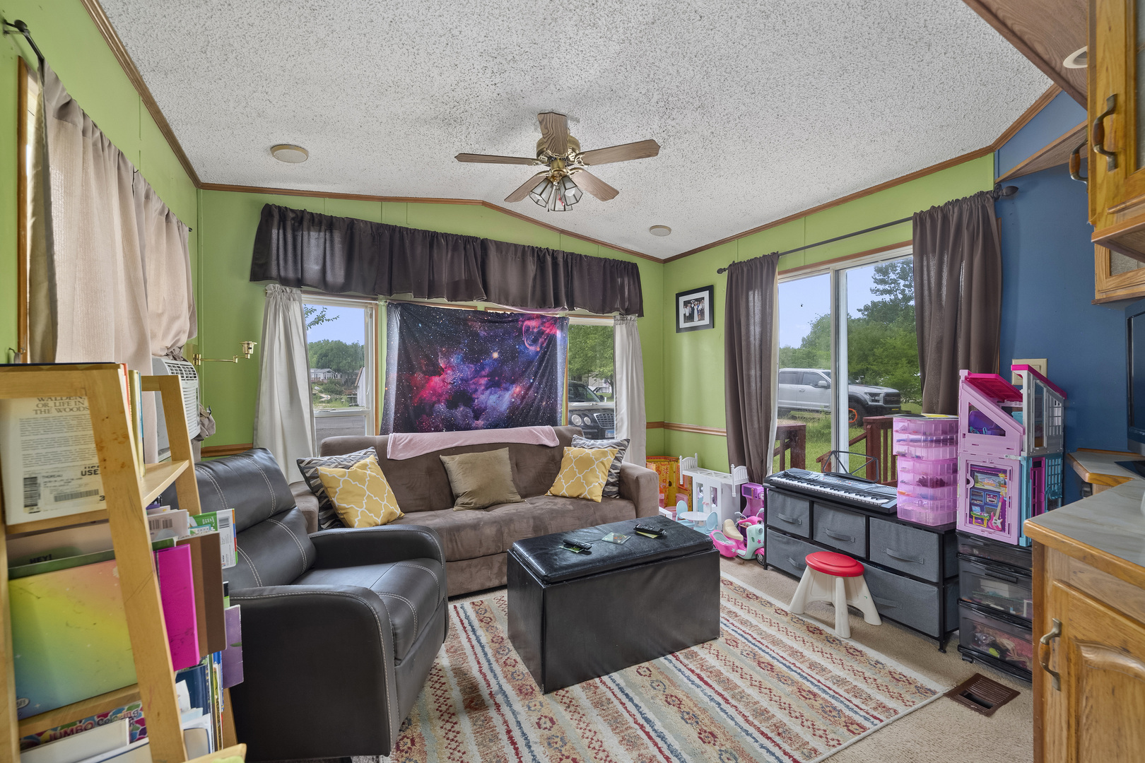 59 Dinosaur Road Wilmington, IL 60481 - Photo 8 of 17 a living room with furniture a flat screen tv and a floor to ceiling window