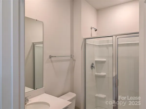 a bathroom with a shower and a toilet