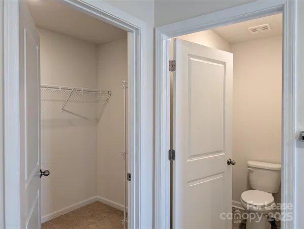 a bathroom with a granite countertop toilet