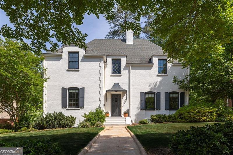 a front view of a house with a garden