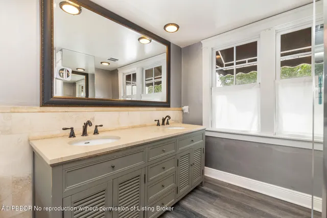 a bathroom with a granite countertop sink mirror and double