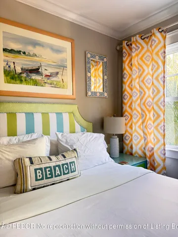 a bedroom with a bed and a painting on the wall