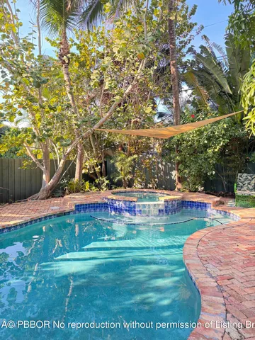 a view of a swimming pool with a yard