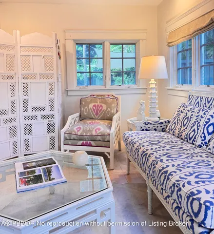 a living room with a bed and a window