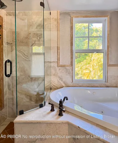 a bathroom with a tub and a shower