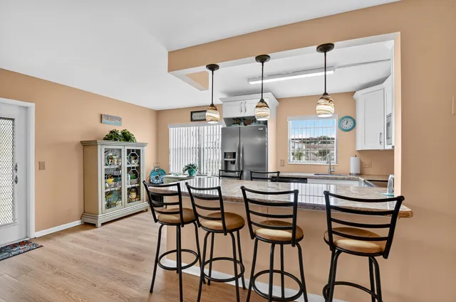 a view of a dining room with furniture and window