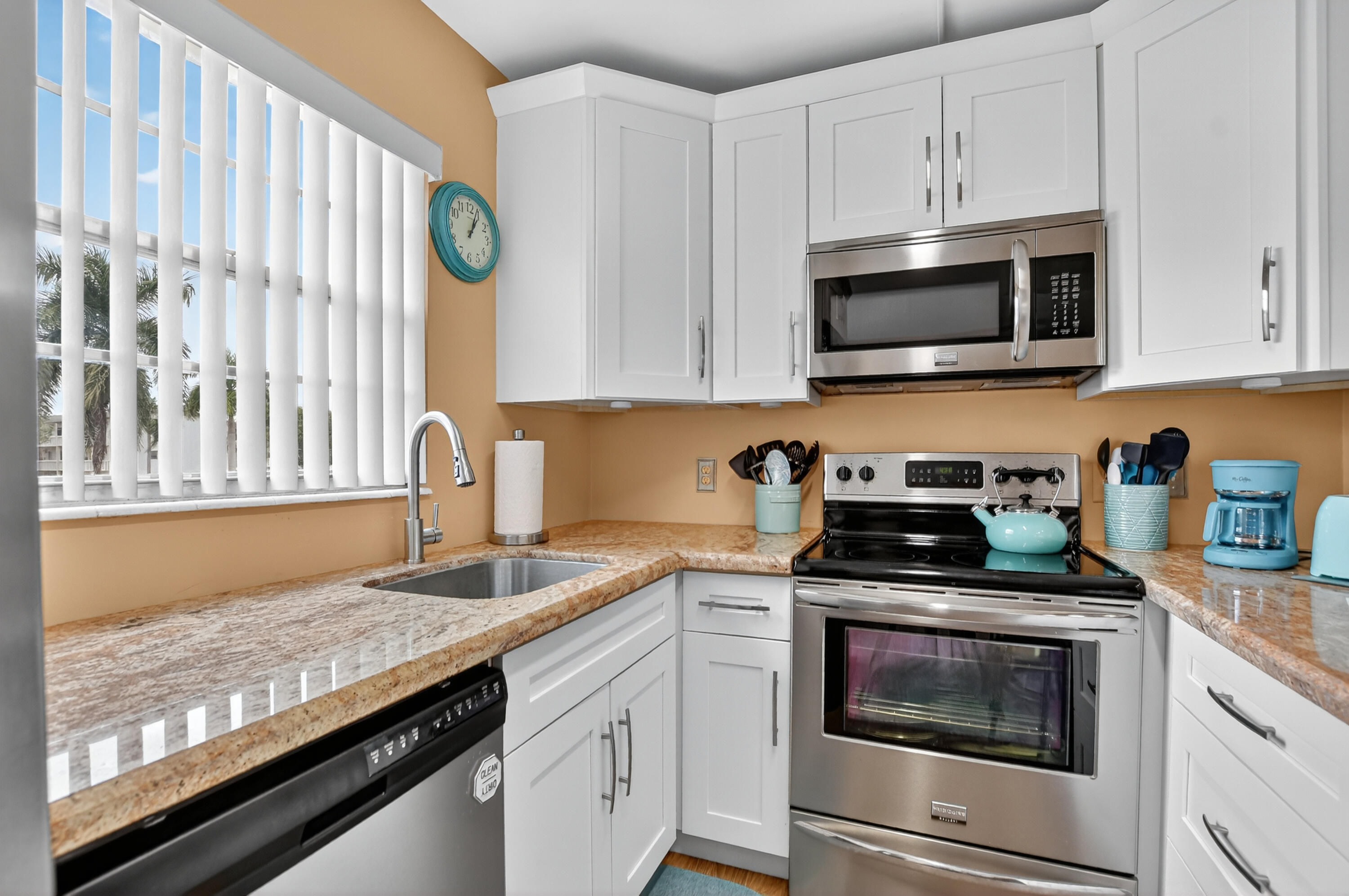 351 Fanshaw I Boca Raton, FL 33434 - Photo 7 of 28 a kitchen with granite countertop white cabinets stainless steel appliances and a sink