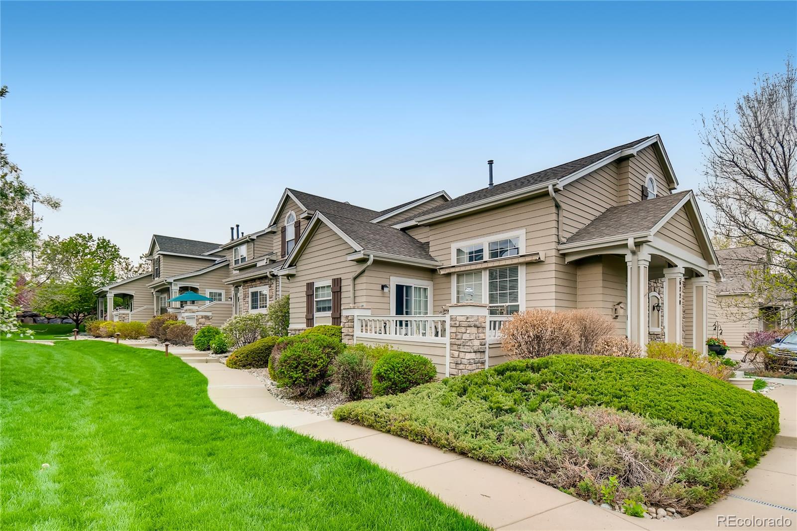 6214 Trailhead Road Highlands Ranch, CO 80130 - Photo 27 of 29 a front view of a house with a yard