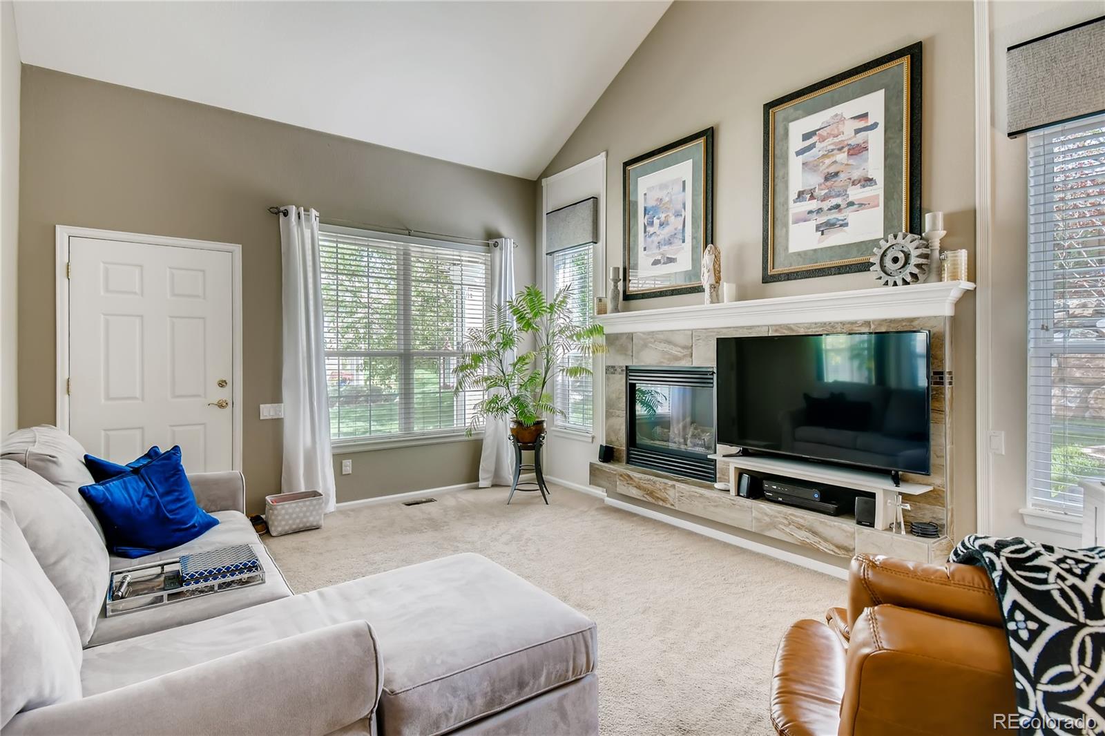 6214 Trailhead Road Highlands Ranch, CO 80130 - Photo 4 of 29 a living room with furniture and a flat screen tv