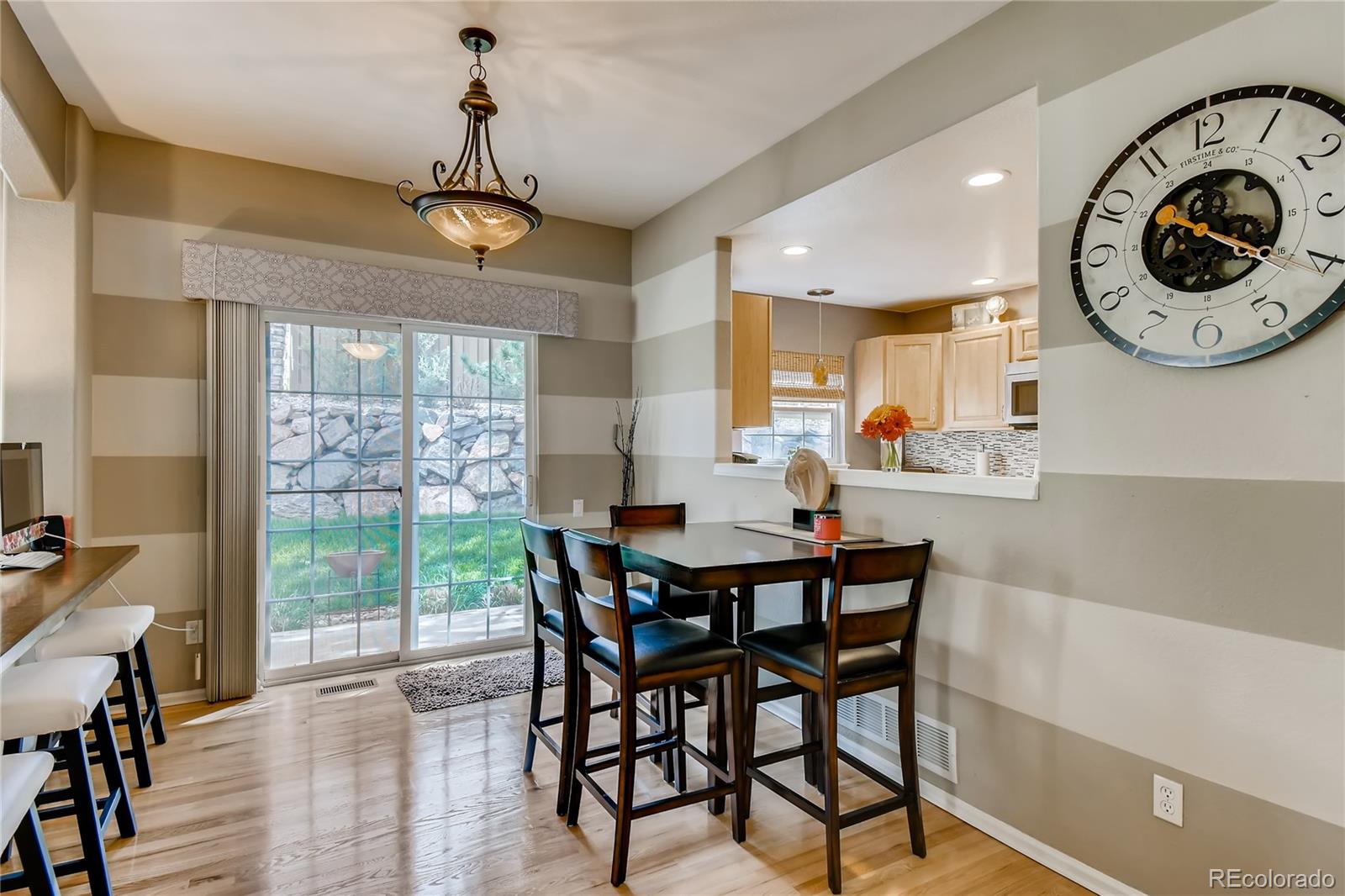 6214 Trailhead Road Highlands Ranch, CO 80130 - Photo 6 of 29 a view of a dining room with furniture window and wooden floor