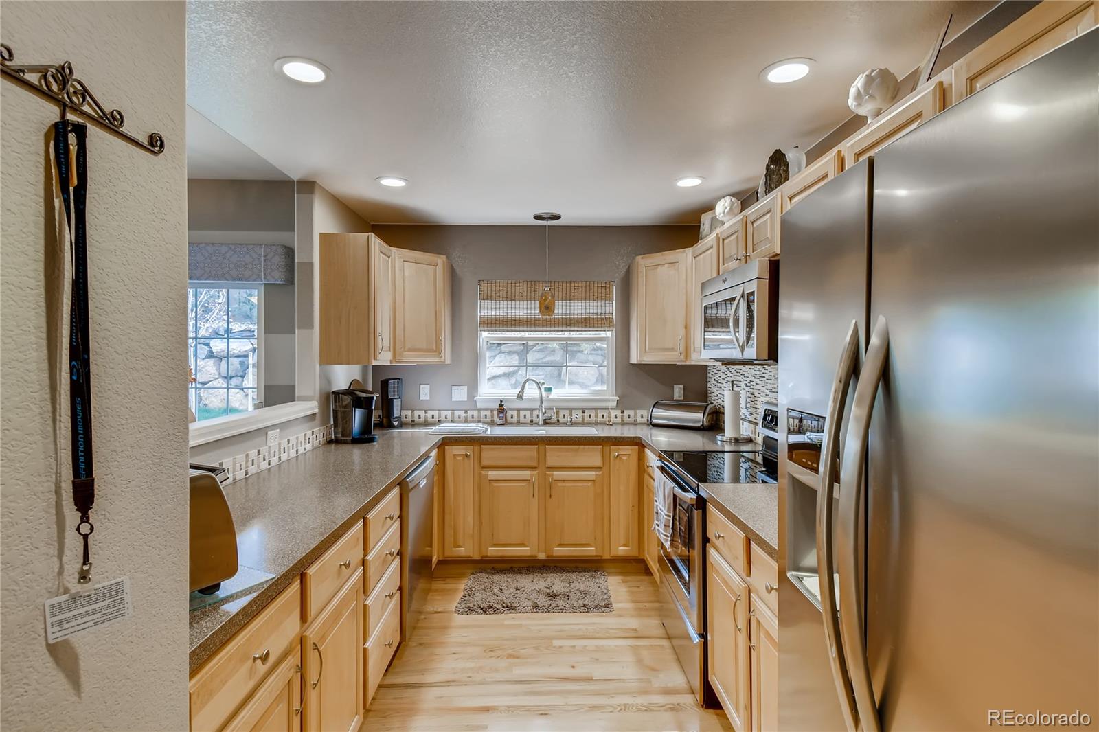 6214 Trailhead Road Highlands Ranch, CO 80130 - Photo 8 of 29 a kitchen with stainless steel appliances granite countertop a sink stove and refrigerator