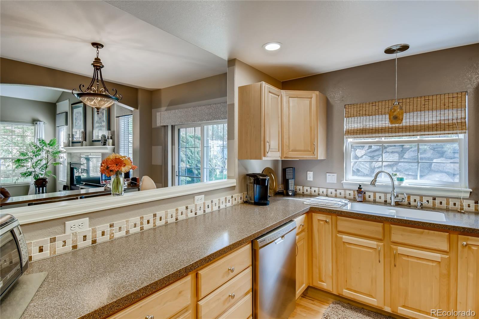 6214 Trailhead Road Highlands Ranch, CO 80130 - Photo 10 of 29 a kitchen with stainless steel appliances granite countertop a sink and a stove