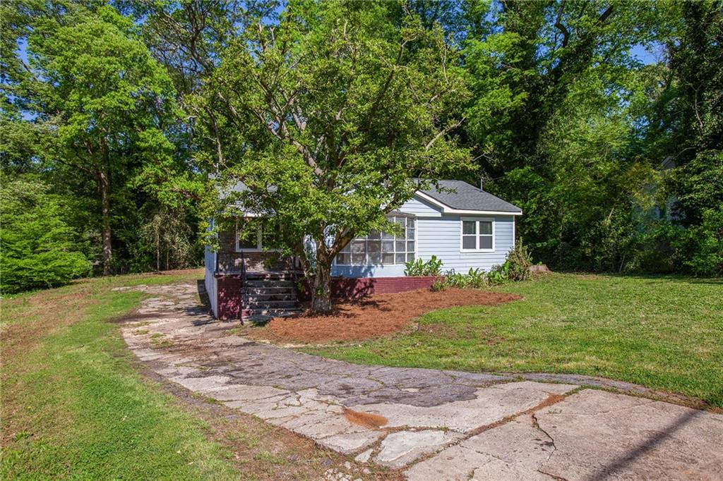 2441 Baxter Road Southwest Atlanta, GA 30315 - Photo 1 of 1 a front view of house with yard and green space