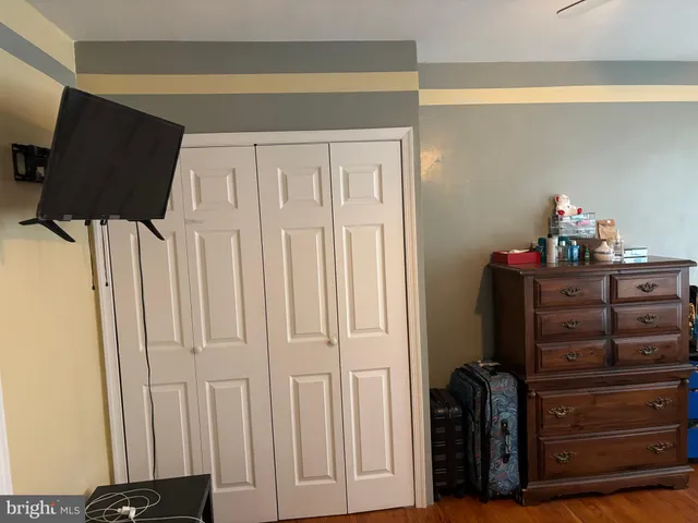 a view of a closet with wooden floor