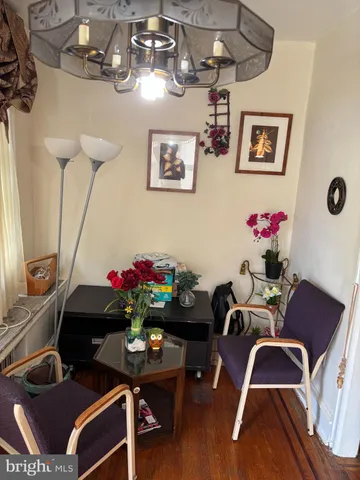 a living room with furniture and flowers