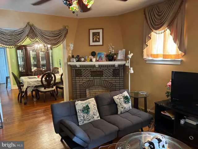 a living room with furniture a dining table and a window