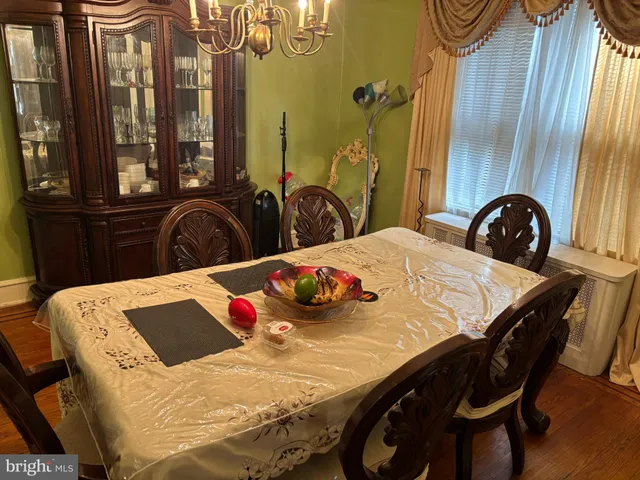 a view of a dining room with furniture and chandelier