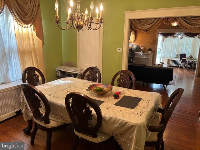 a view of a dining room with furniture and chandelier